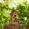 Glitzhome® 11.5" Yellow Washed with Rattan Distressed Wood Cottage Birdhouse